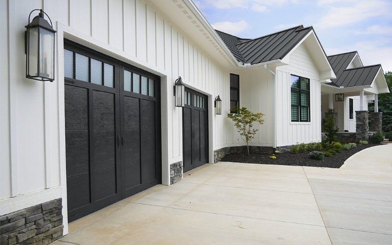Black carriage-style garage door on traditional home