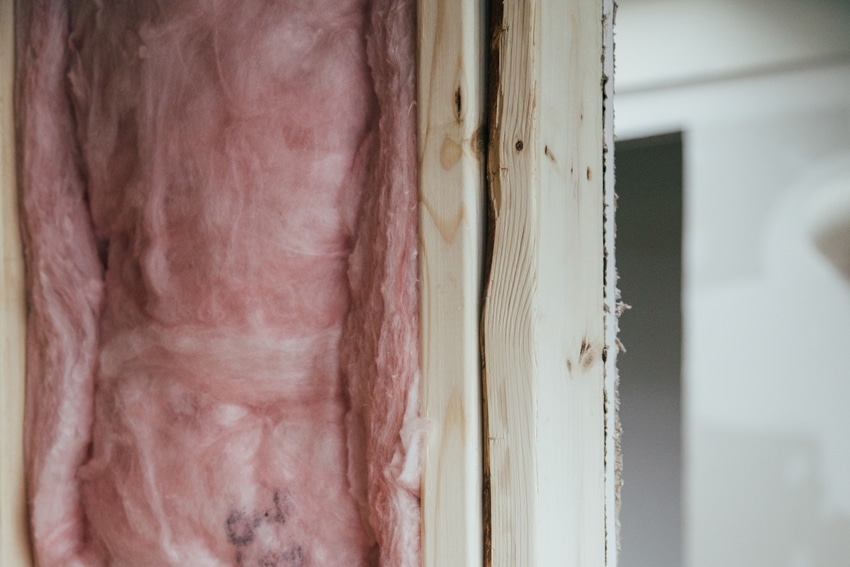 Close-up view of insulation after renovations to wall between garage and interior of Thornton, CO home