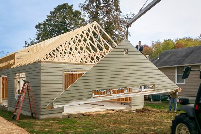 Construction workers assembling a prefabricated garage