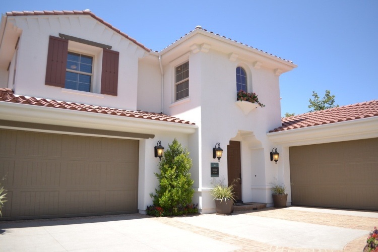 Spanish style suburban home with exterior lights