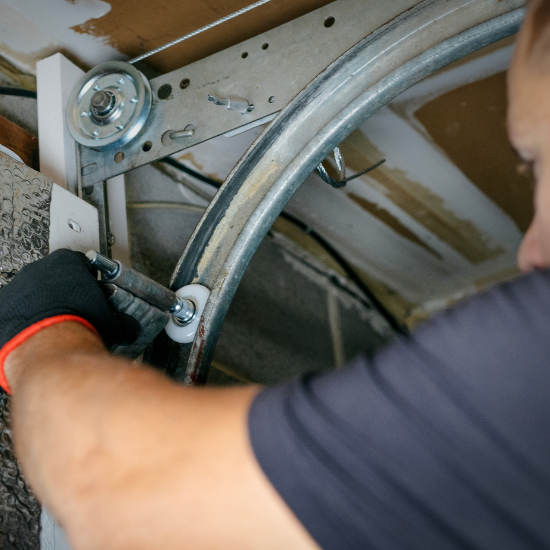 Repair tech installing new track wheels