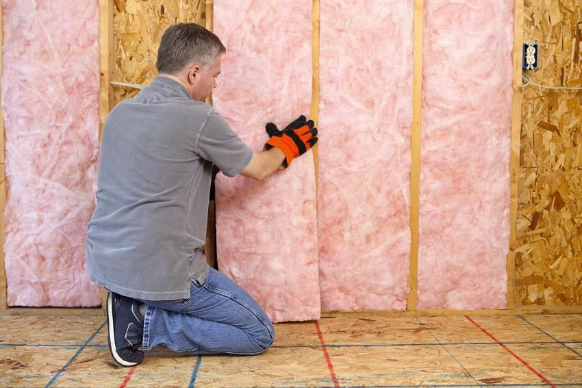 Overhead door installation professional installing new garage door with insulation
