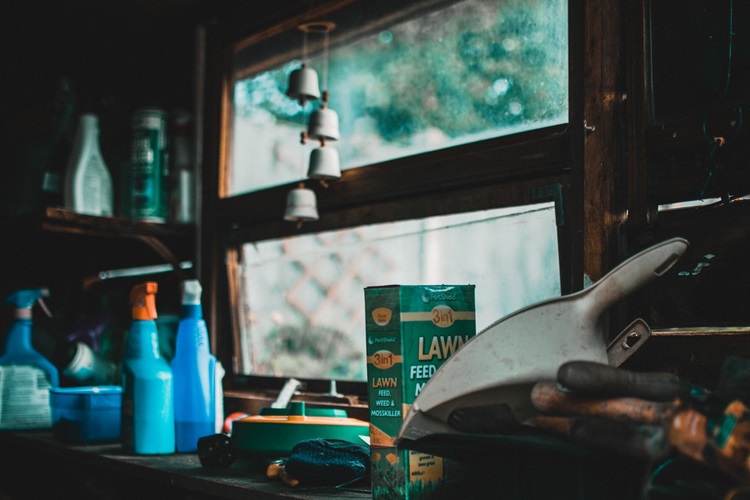 Residential garage with cleaning supplies, tools and window