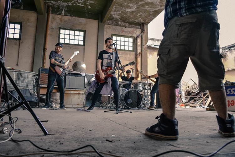 Musicians performing music in garage with open garage door