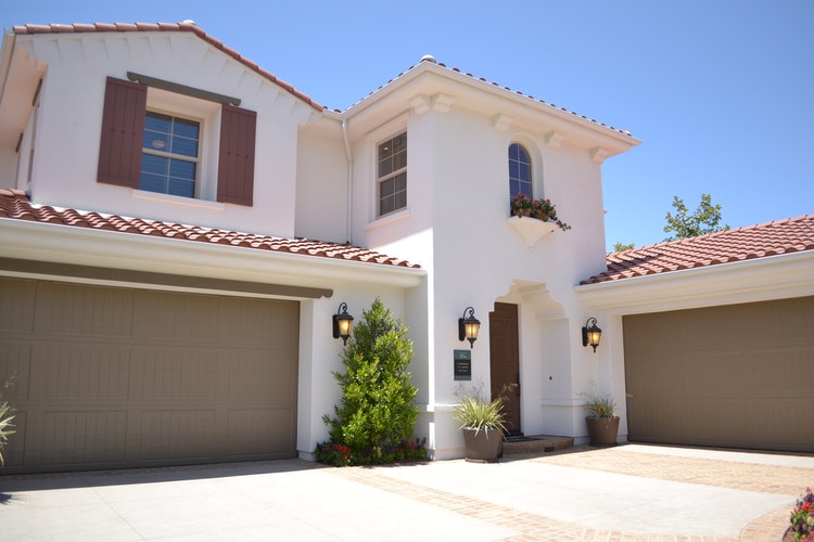 Beige house with two garage doors