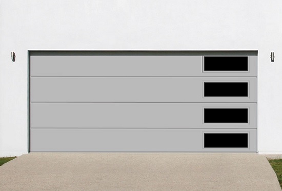 Gray flush panel garage door with asymetrical windows on white two-car garage