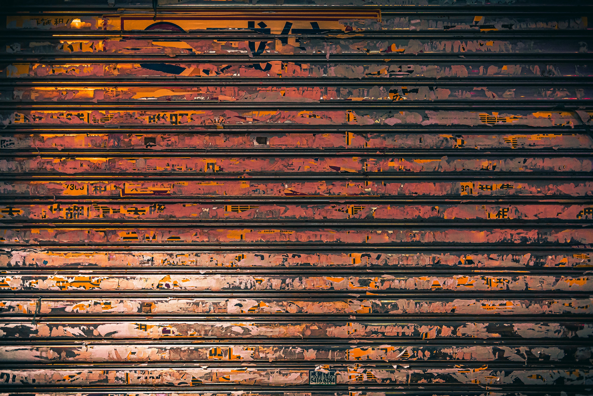 Paneled two-car metal garage door covered in rust
