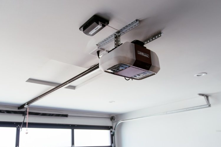 Liftmaster overhead door opener mounted to ceiling of residential garage