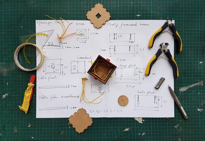 Handwritten home repair plans, pliers, cables, and more for do-it-yourself home repair