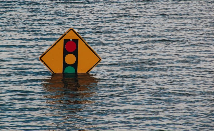 Traffic Sign Partially Submerged by Floodwater