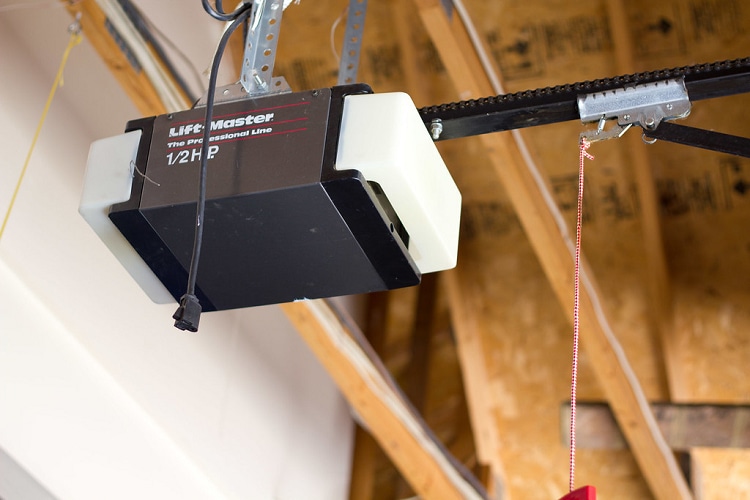 Liftmaster garage door opener attached to ceiling of residential garage