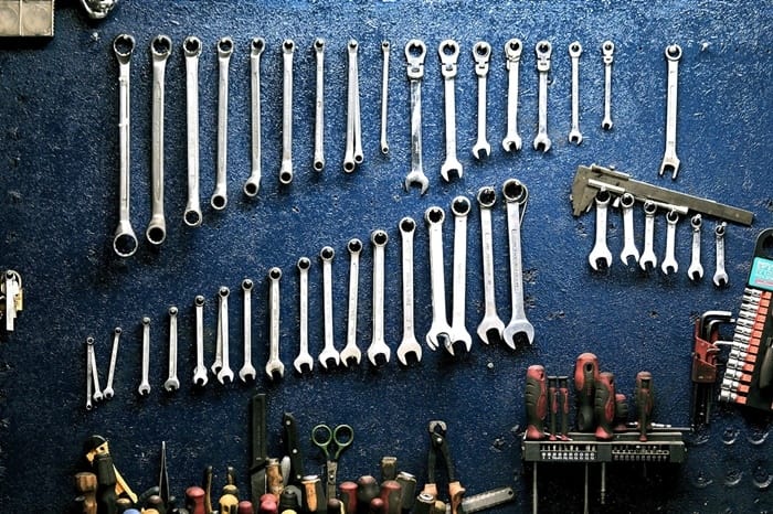 Wrenches on wall above tools for garage door maintenance