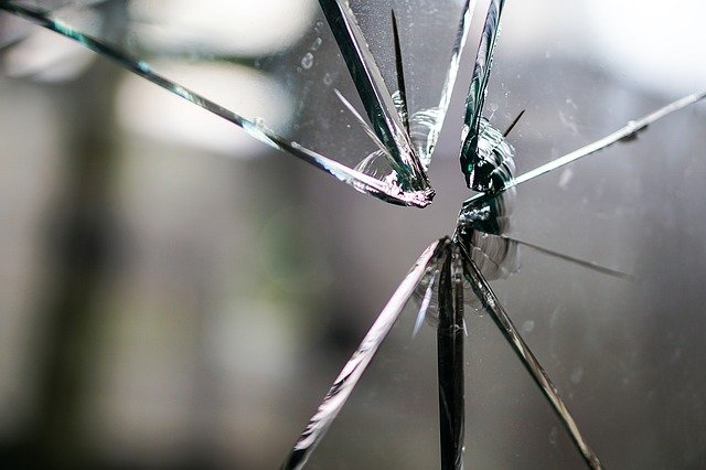 Close Up View of Shattered Glass in Broken Window of Garage Door